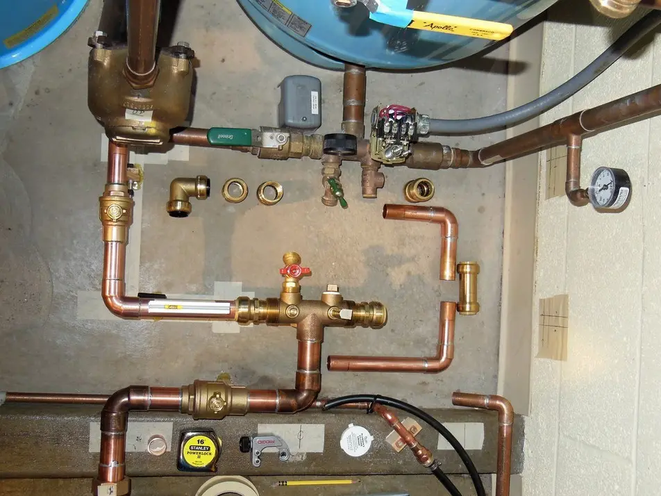 Plumber assembling and fitting water pipes